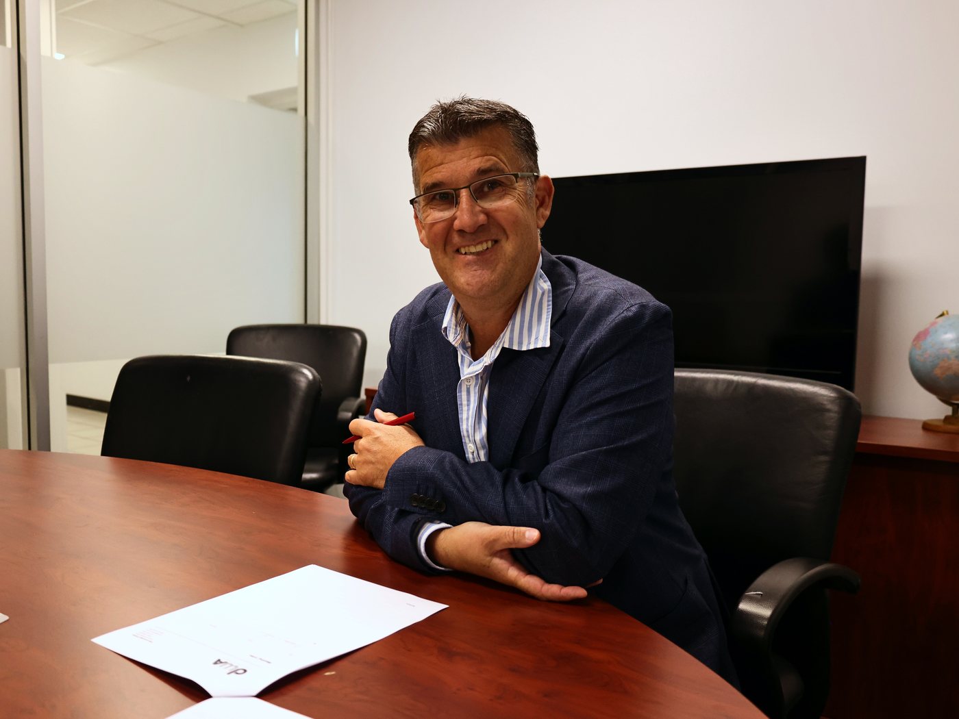 Darren Warner at the boardroom table in the DWA office